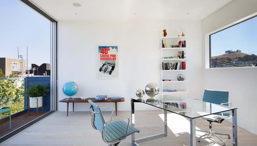 Medium sized contemporary study in San Francisco with white walls, light hardwood flooring, no fireplace, a freestanding desk and beige floors.