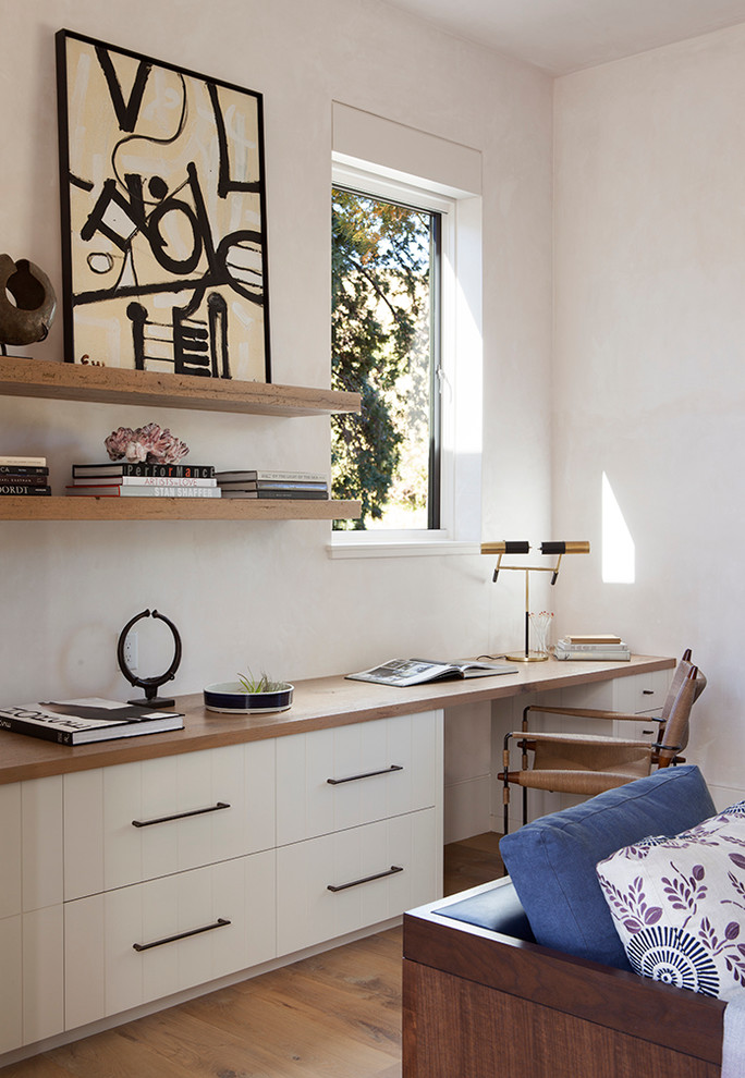 Foto di un ufficio design con pareti beige, pavimento in legno massello medio e scrivania incassata