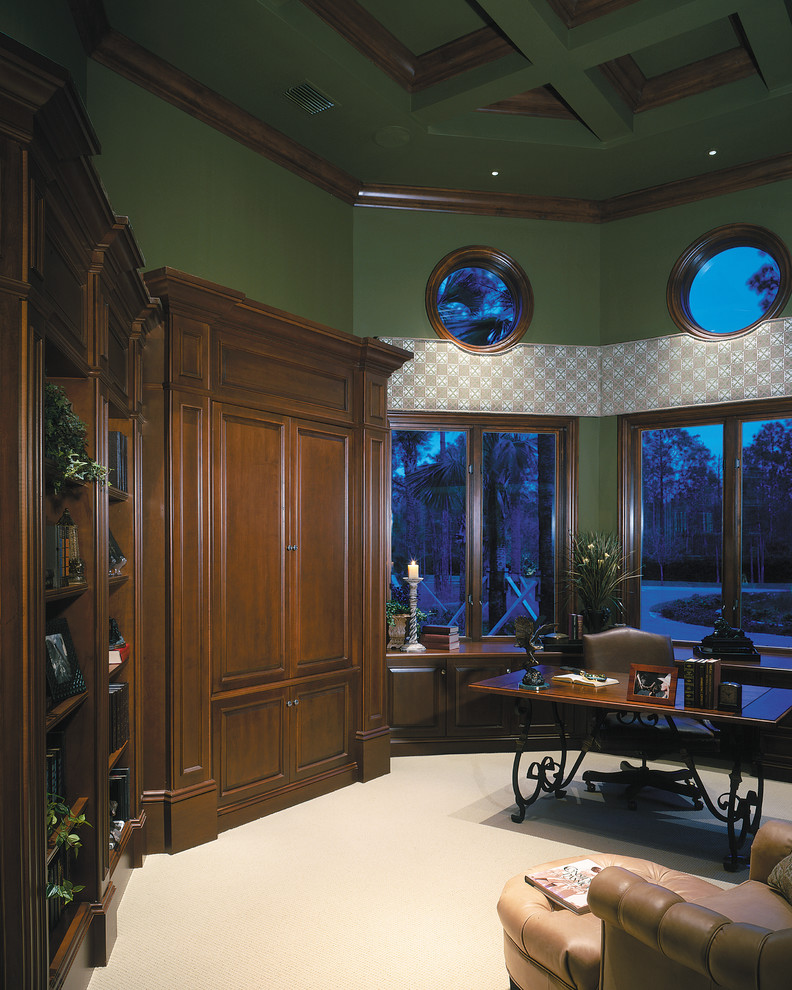 Ejemplo de despacho tropical grande sin chimenea con paredes verdes, moqueta y escritorio independiente