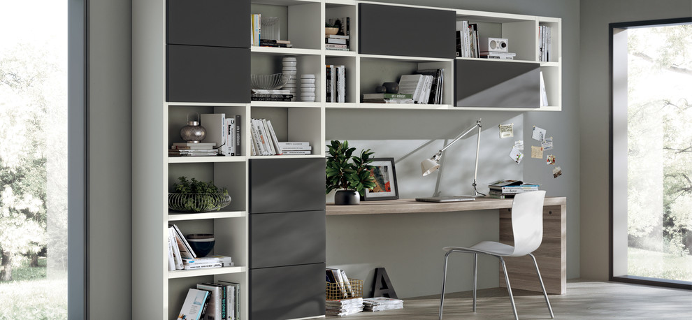Foto de despacho minimalista pequeño con paredes grises, suelo de cemento y escritorio empotrado