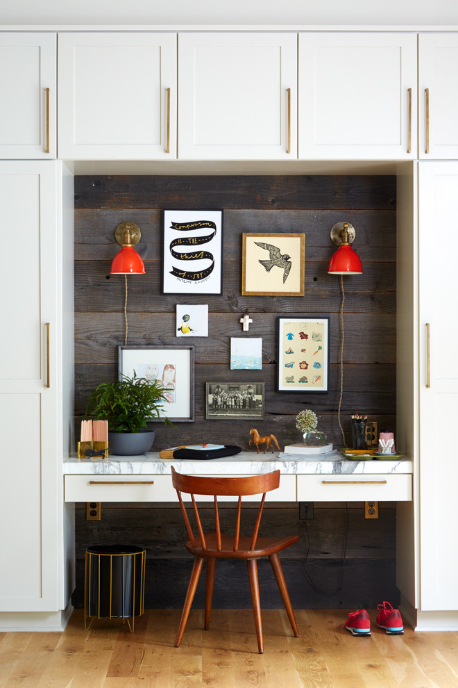 Example of a farmhouse built-in desk light wood floor study room design in Portland