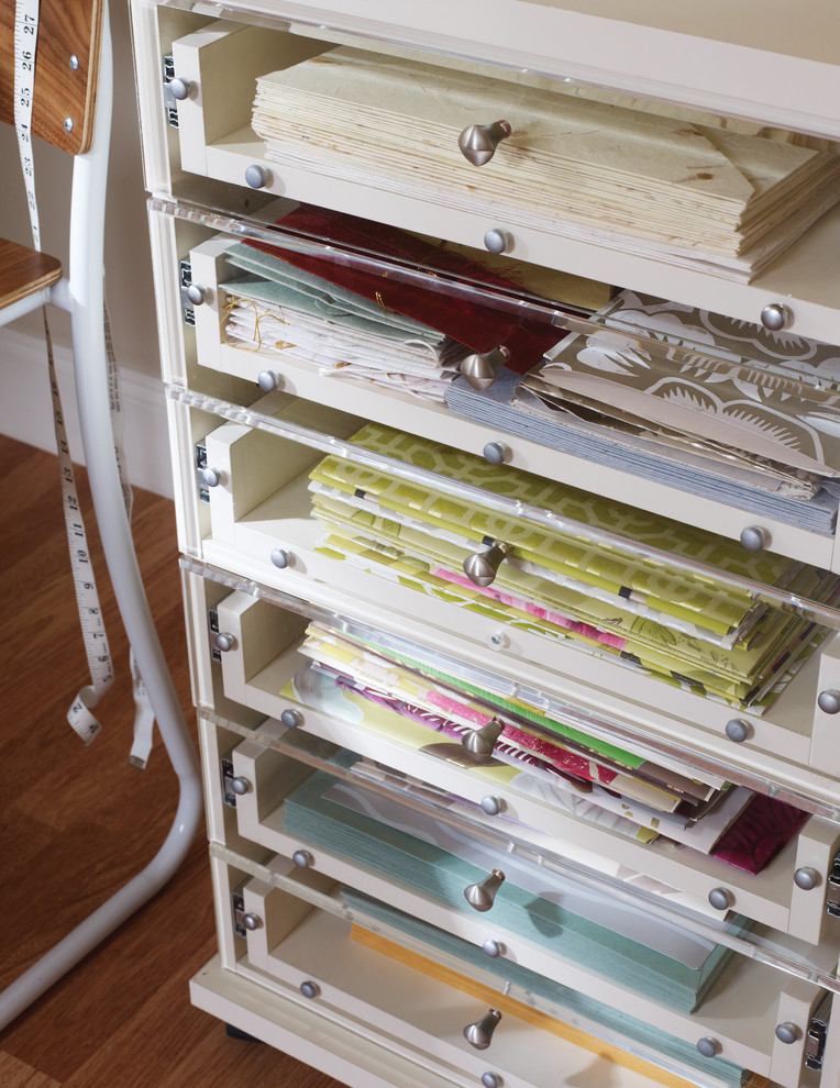 Craft room - mid-sized contemporary built-in desk medium tone wood floor craft room idea in Nashville with beige walls and no fireplace