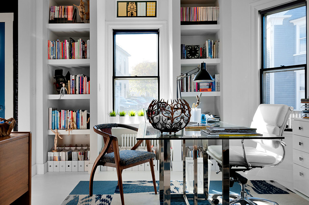 This is an example of a contemporary home office in Boston with white walls.