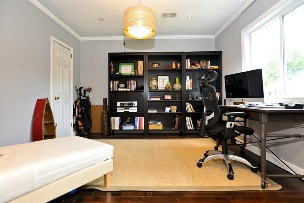 Diseño de despacho clásico renovado de tamaño medio sin chimenea con biblioteca, paredes grises, suelo de madera oscura y escritorio independiente