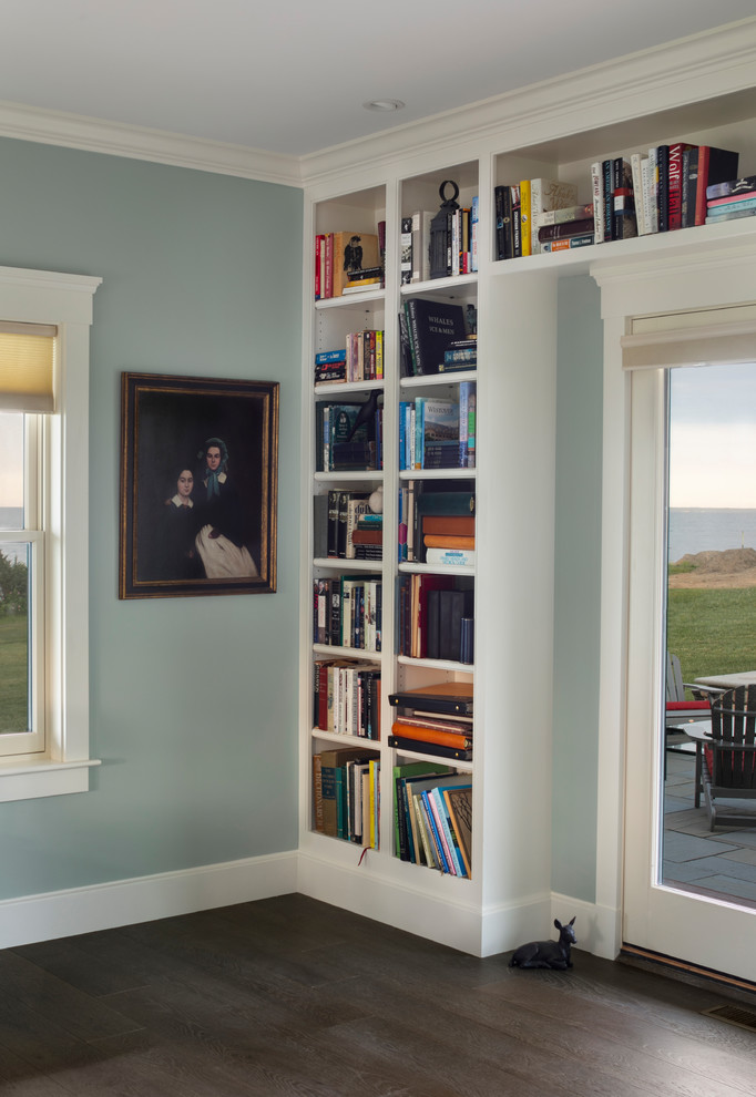 Home office library - large coastal freestanding desk dark wood floor home office library idea in Providence with blue walls and no fireplace