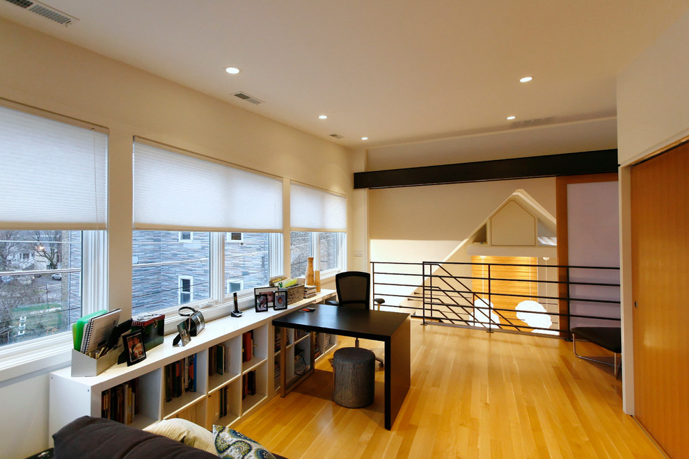 Esempio di un ufficio minimalista di medie dimensioni con parquet chiaro e scrivania autoportante