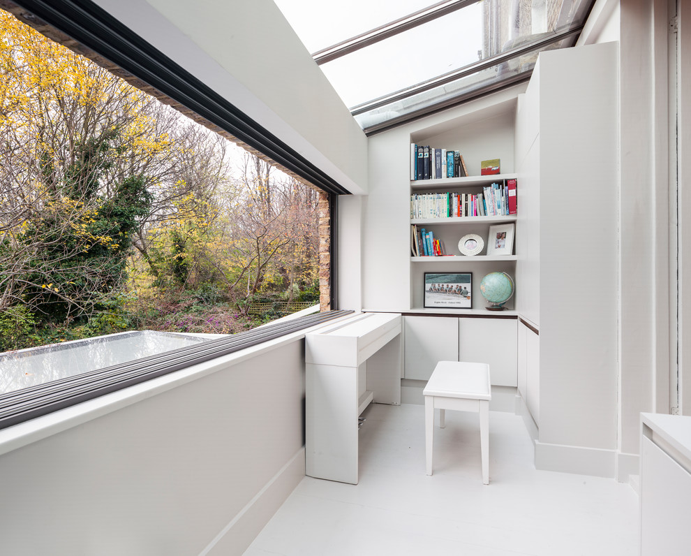 Photo of a medium sized contemporary study in London with white walls and white floors.