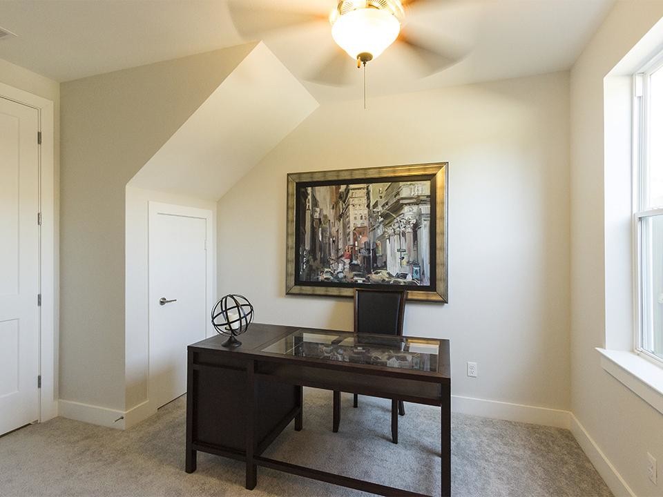 Medium sized contemporary study in Houston with carpet, no fireplace, a freestanding desk, beige floors and grey walls.