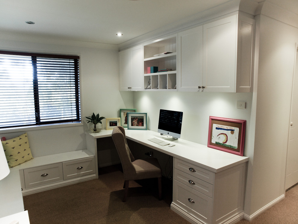 Mid-sized elegant built-in desk carpeted study room photo in Wollongong with white walls