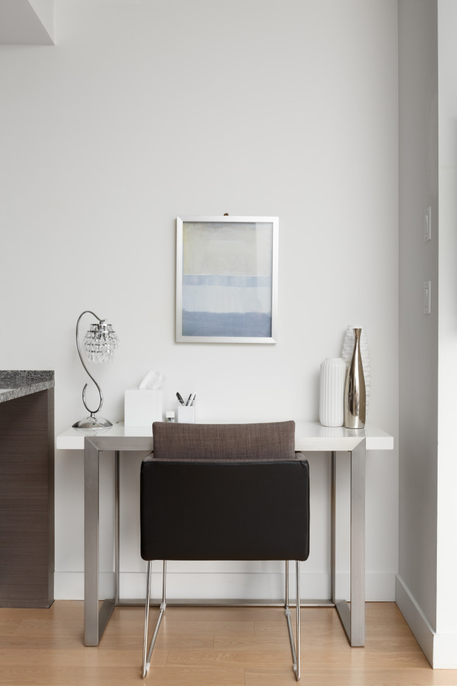 Réalisation d'un petit bureau design avec parquet clair, un mur blanc, un bureau indépendant et un sol beige.