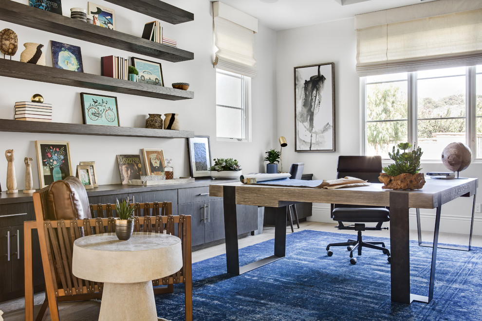 Example of a mid-sized transitional freestanding desk light wood floor and beige floor study room design in Orange County with white walls and no fireplace