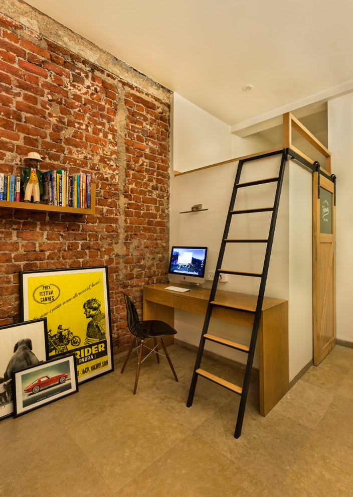 This is an example of an urban home office in Mumbai with white walls, a freestanding desk and brown floors.