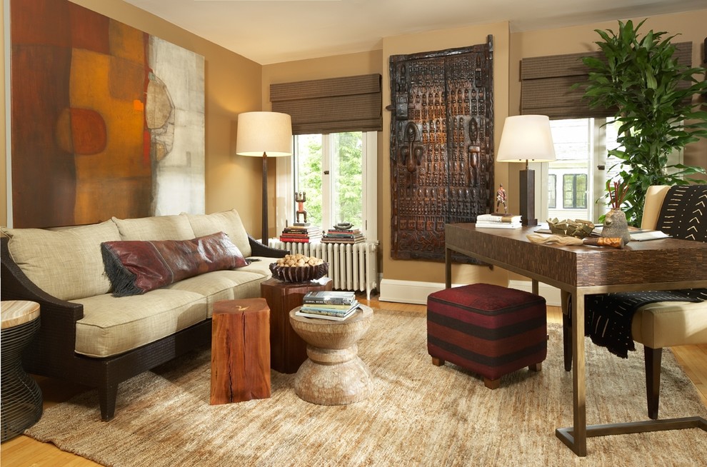Example of a trendy freestanding desk medium tone wood floor home office design in Minneapolis with beige walls