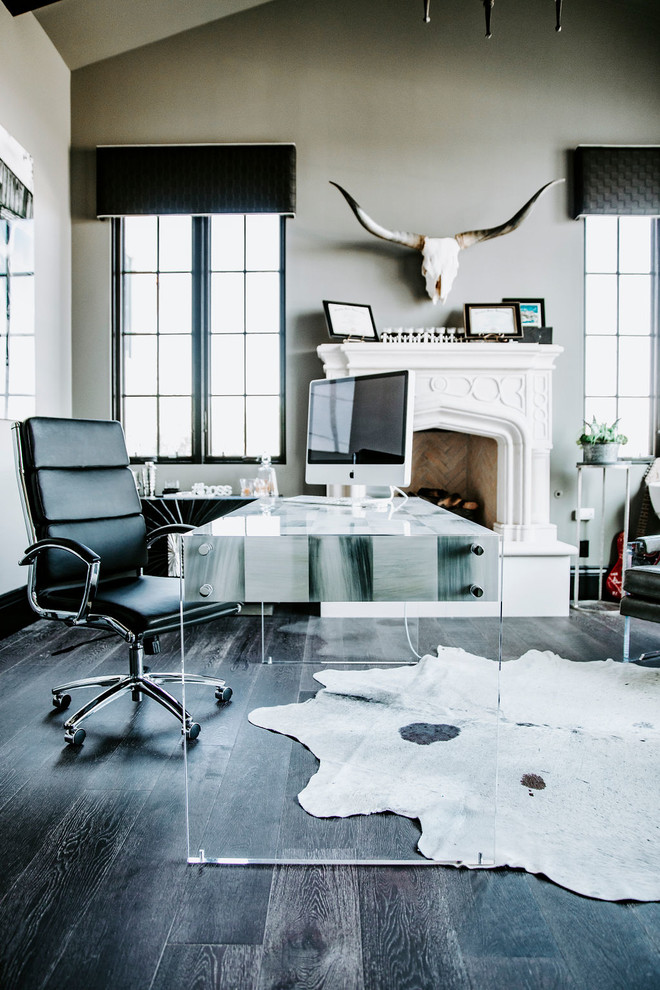 Diseño de despacho moderno grande con paredes grises, suelo de madera oscura, escritorio independiente y suelo negro