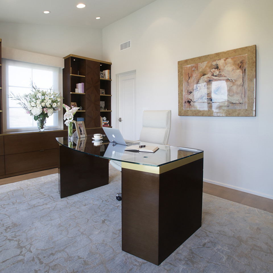 This is an example of a medium sized contemporary study in Los Angeles with white walls, light hardwood flooring and a freestanding desk.