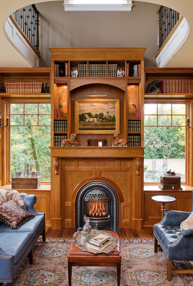 На фото: кабинет в викторианском стиле с паркетным полом среднего тона, стандартным камином и фасадом камина из дерева