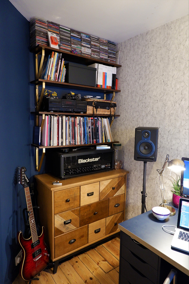 Example of a small trendy freestanding desk medium tone wood floor and brown floor home studio design in Other with blue walls