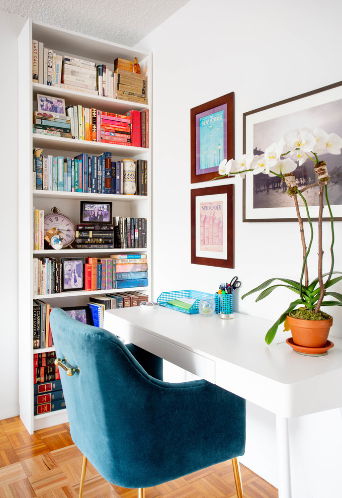 Kleines Eklektisches Arbeitszimmer ohne Kamin mit weißer Wandfarbe, hellem Holzboden, freistehendem Schreibtisch und beigem Boden in New York