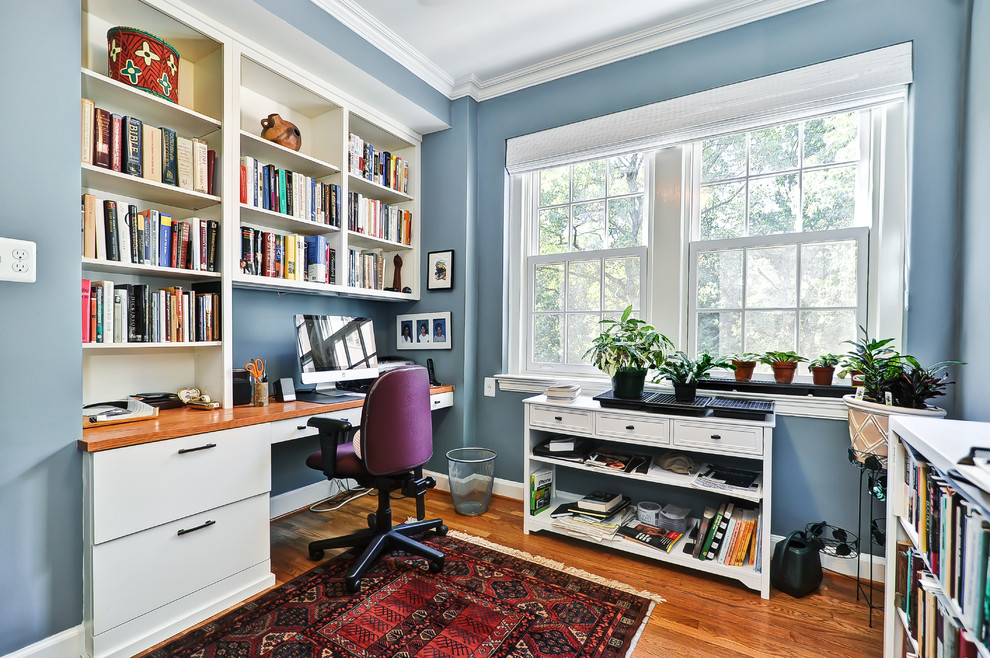 Example of a classic built-in desk home office design in DC Metro with blue walls
