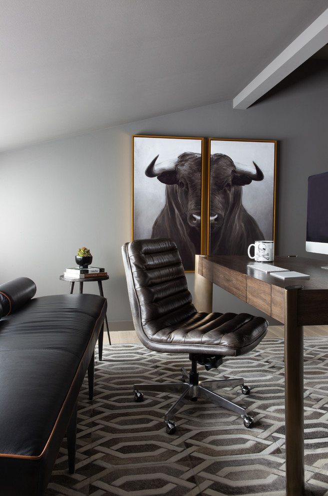 Diseño de despacho minimalista pequeño con paredes grises, suelo de madera clara, escritorio independiente y suelo marrón