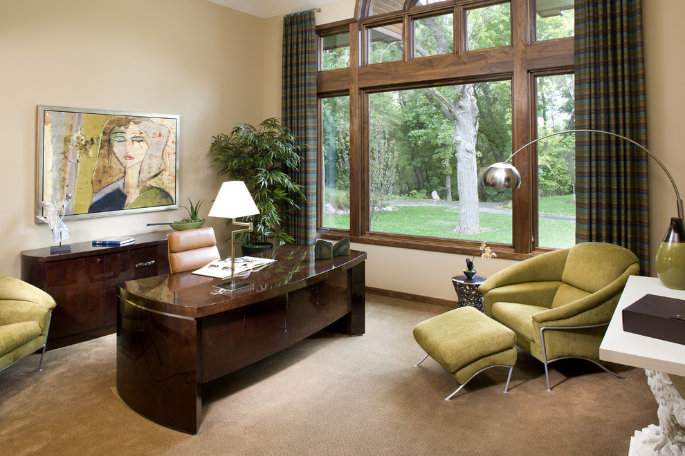 Contemporary home office in Minneapolis with beige walls, carpet and a freestanding desk.