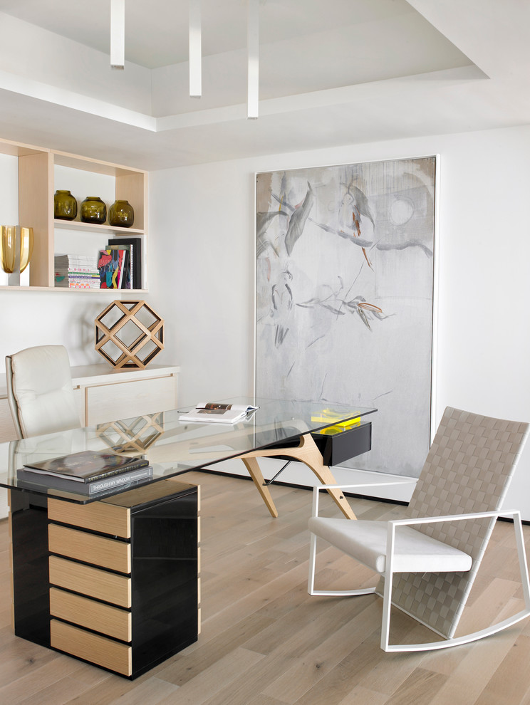Medium sized contemporary study in Miami with white walls, light hardwood flooring, a freestanding desk and beige floors.