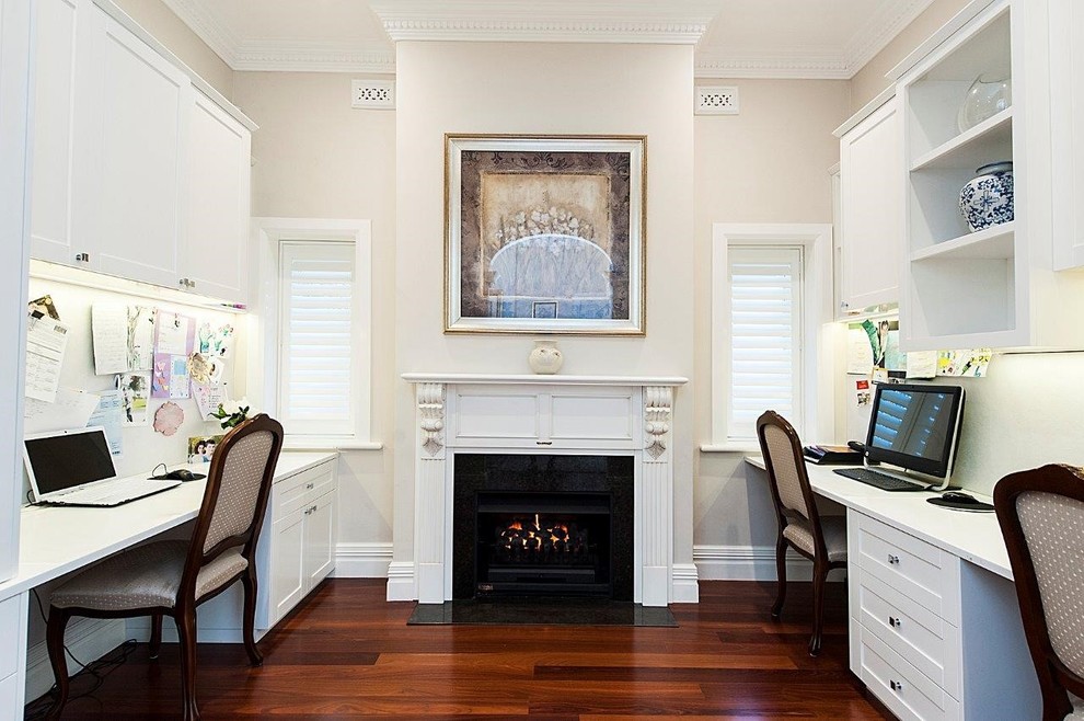 Inspiration for a mid-sized timeless built-in desk dark wood floor study room remodel in Perth with a standard fireplace and a plaster fireplace