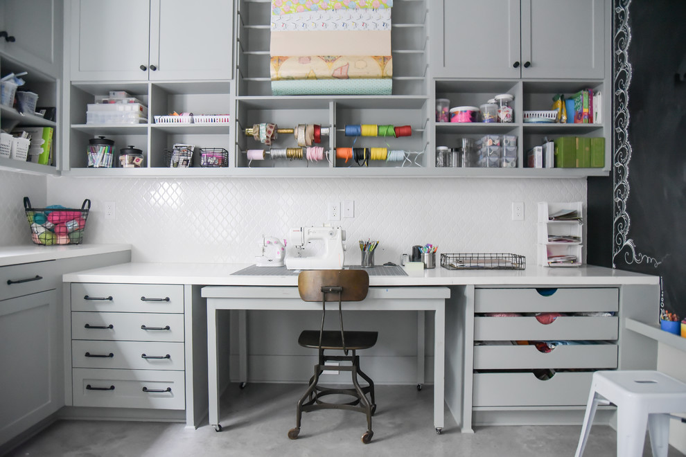 Diseño de despacho clásico renovado con paredes negras, suelo de cemento, escritorio empotrado y suelo gris
