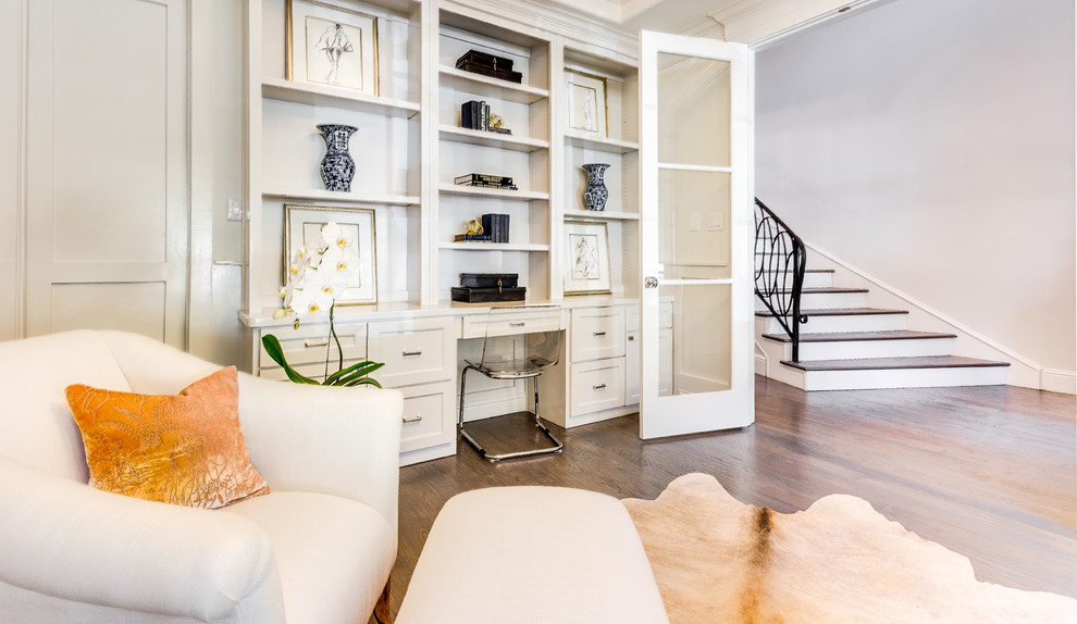 Photo of a traditional study in Dallas with white walls, medium hardwood flooring and a freestanding desk.