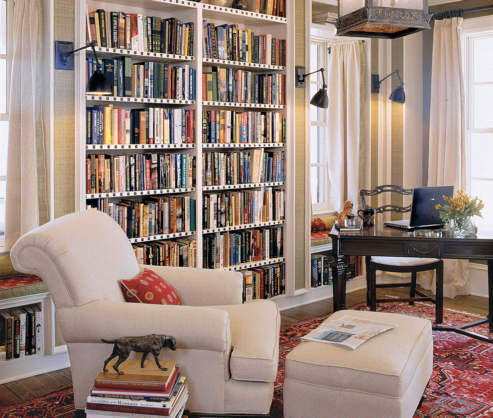 Elegant freestanding desk dark wood floor home office photo in Charleston