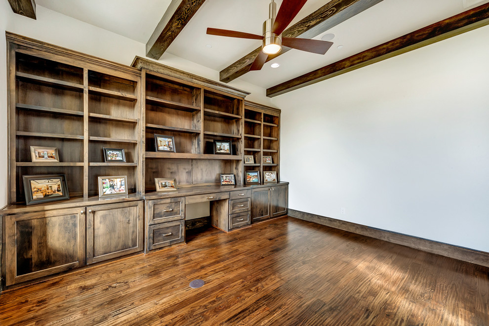 This is an example of a medium sized classic study in Dallas with medium hardwood flooring and a built-in desk.