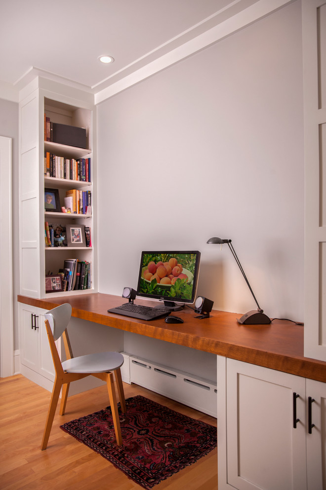 This is an example of a medium sized classic study in Minneapolis with grey walls, light hardwood flooring, no fireplace, a built-in desk and beige floors.