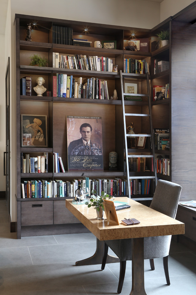 Cette image montre un bureau design de taille moyenne avec un sol en carrelage de céramique, un bureau indépendant, un sol gris, une bibliothèque ou un coin lecture, un mur blanc, une cheminée double-face et un manteau de cheminée en métal.