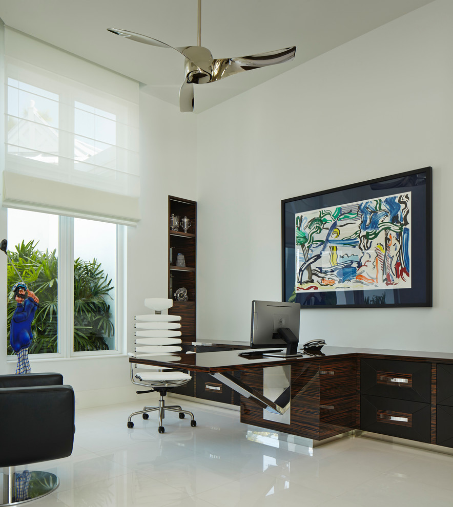 Trendy built-in desk white floor home office photo in Miami with white walls