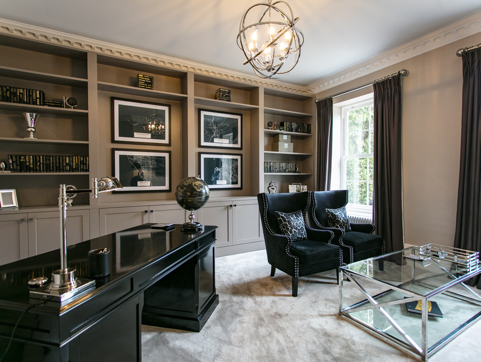 This is an example of a large traditional study in Surrey with carpet, a freestanding desk, black walls and white floors.