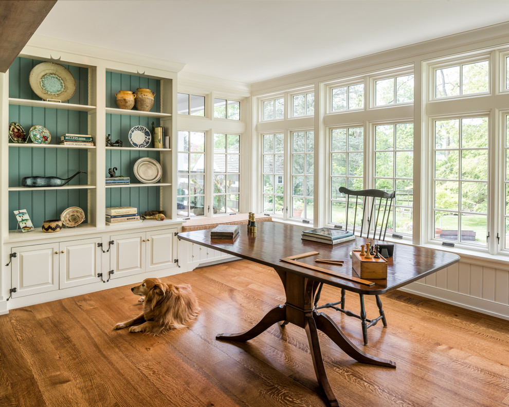 Diseño de despacho clásico de tamaño medio sin chimenea con suelo de madera en tonos medios, escritorio independiente, suelo naranja y paredes beige