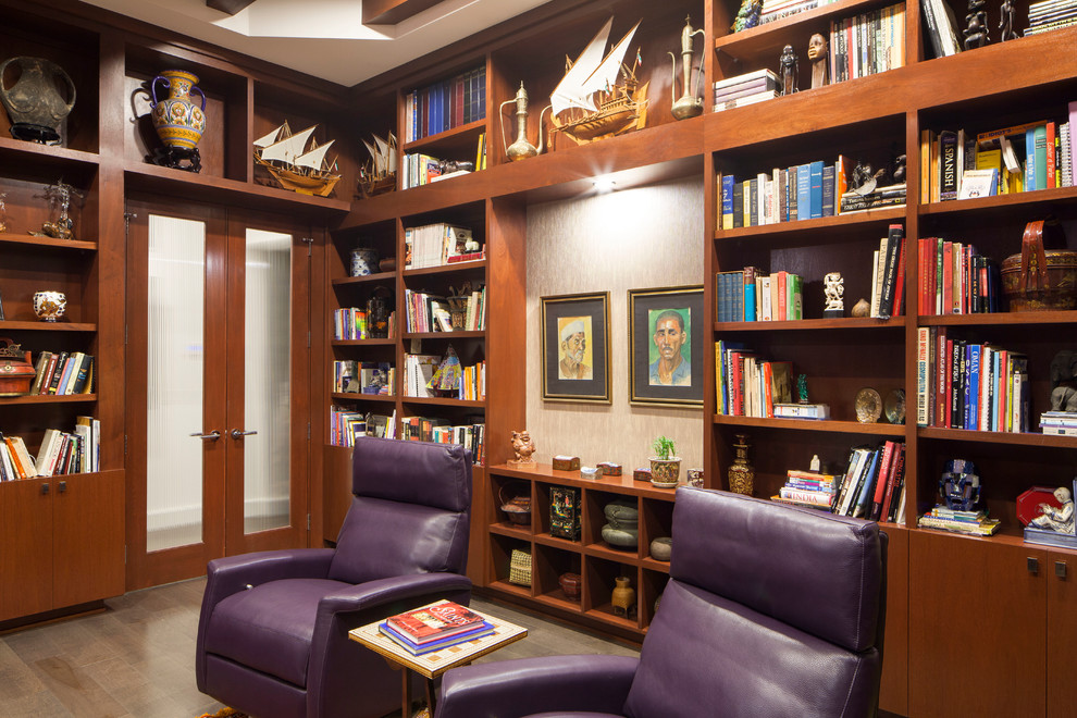 World-inspired home office in Austin with dark hardwood flooring.