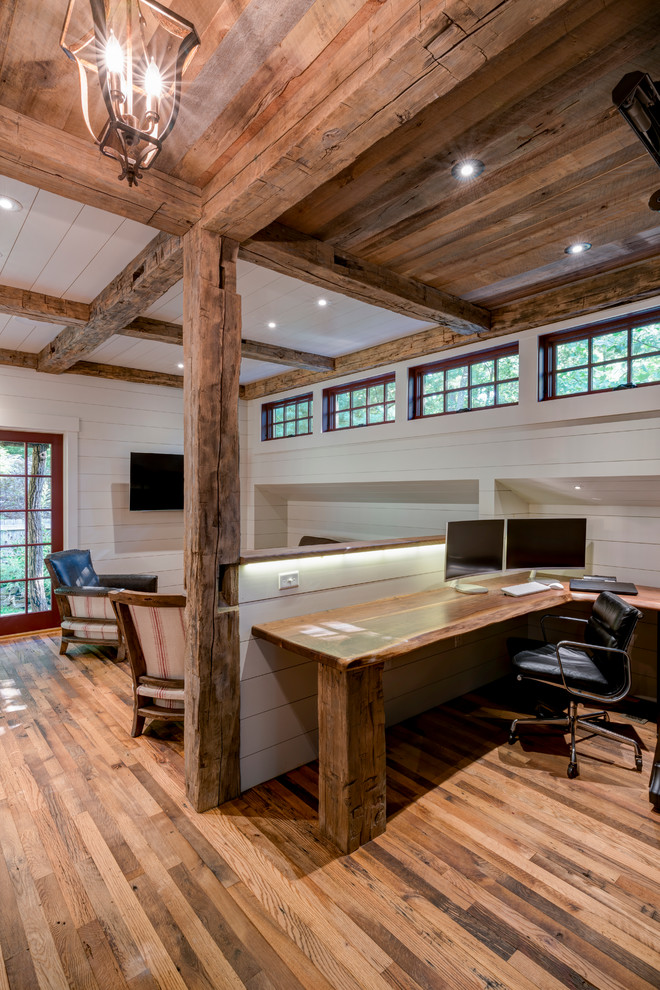 Cette photo montre un bureau montagne de taille moyenne et de type studio avec un sol en bois brun, aucune cheminée et un bureau intégré.