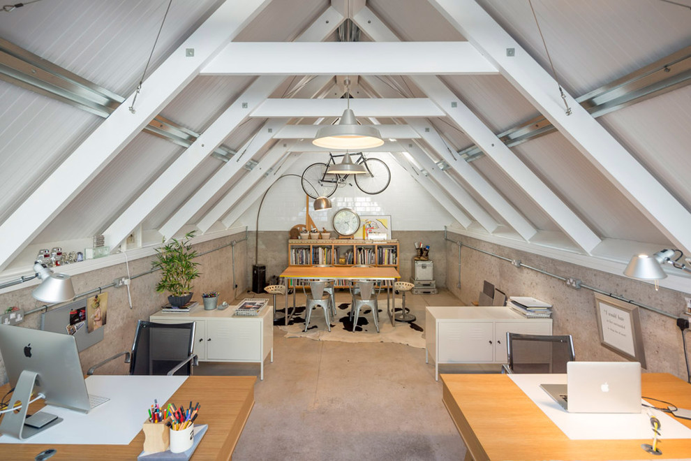 Urban home studio in Hampshire with white walls, concrete flooring and a freestanding desk.