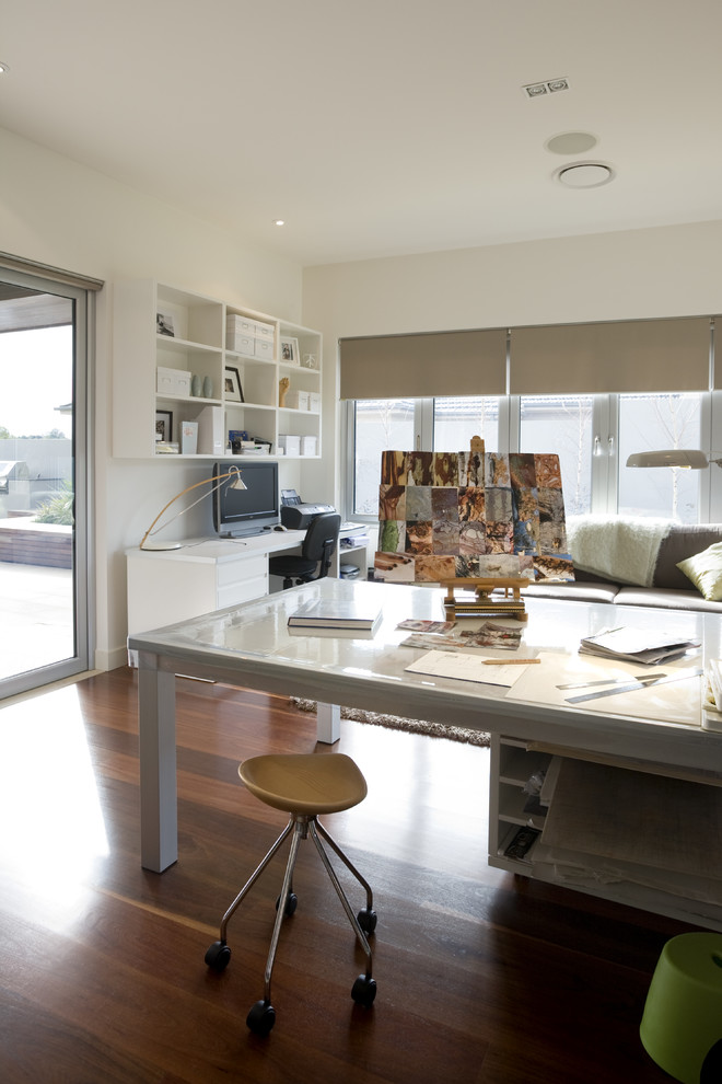 Großes Modernes Arbeitszimmer ohne Kamin mit Studio, weißer Wandfarbe, braunem Holzboden und freistehendem Schreibtisch in Sydney