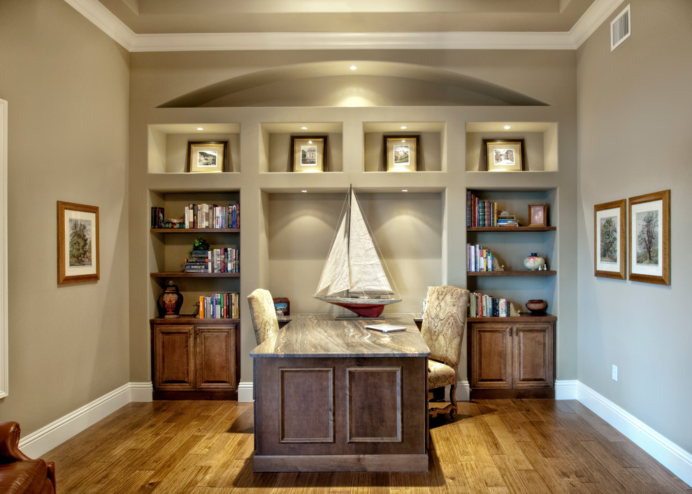 Design ideas for a classic home office in Tampa with green walls, medium hardwood flooring and a built-in desk.