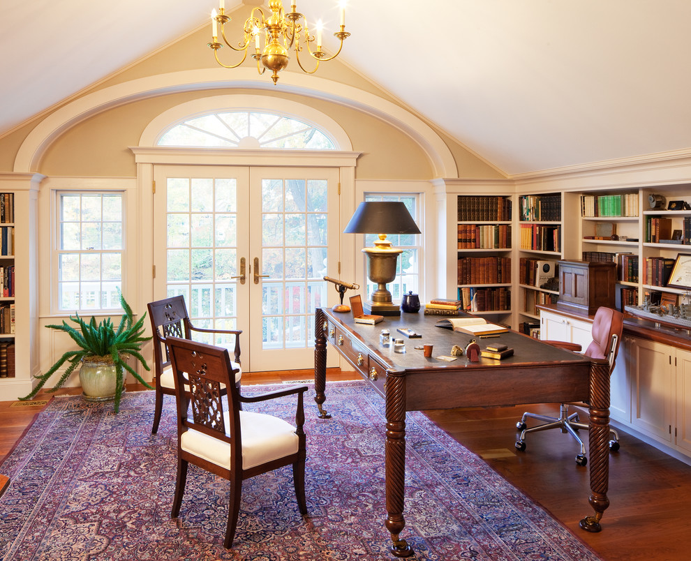 Design ideas for a medium sized classic study in Boston with beige walls, medium hardwood flooring and a freestanding desk.