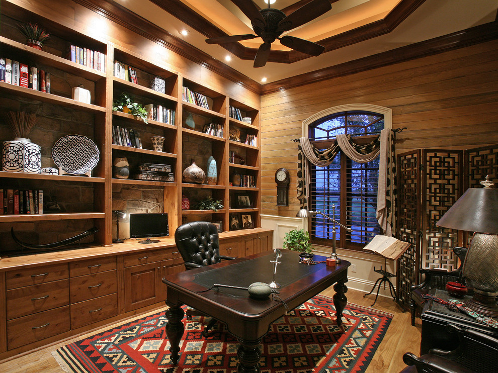 This is an example of a mediterranean home office in Miami with medium hardwood flooring and a freestanding desk.