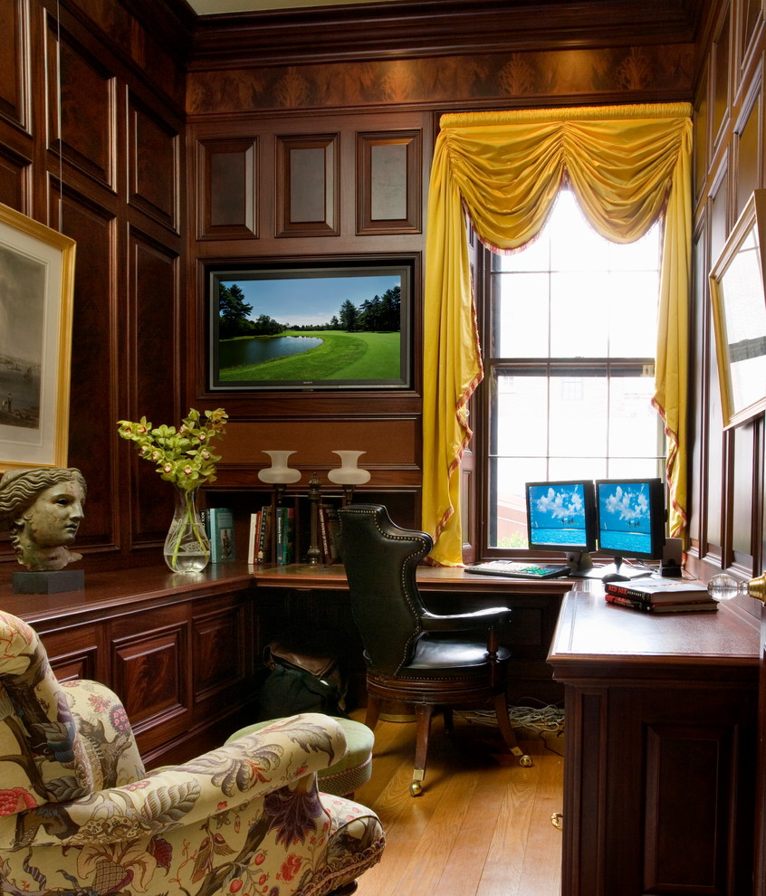 Example of a small classic built-in desk light wood floor study room design in Boston with brown walls