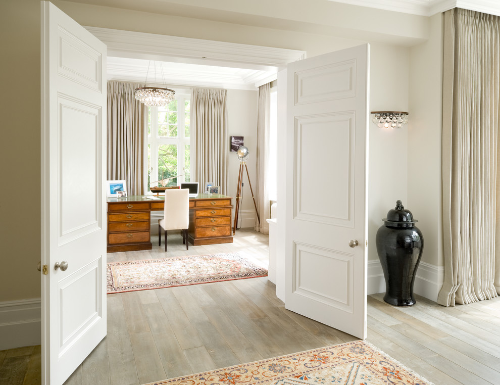 Inspiration for a victorian study in London with beige walls, light hardwood flooring, a freestanding desk and beige floors.