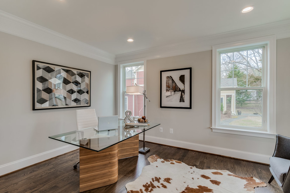 Traditional study in DC Metro with grey walls, dark hardwood flooring, a freestanding desk and brown floors.