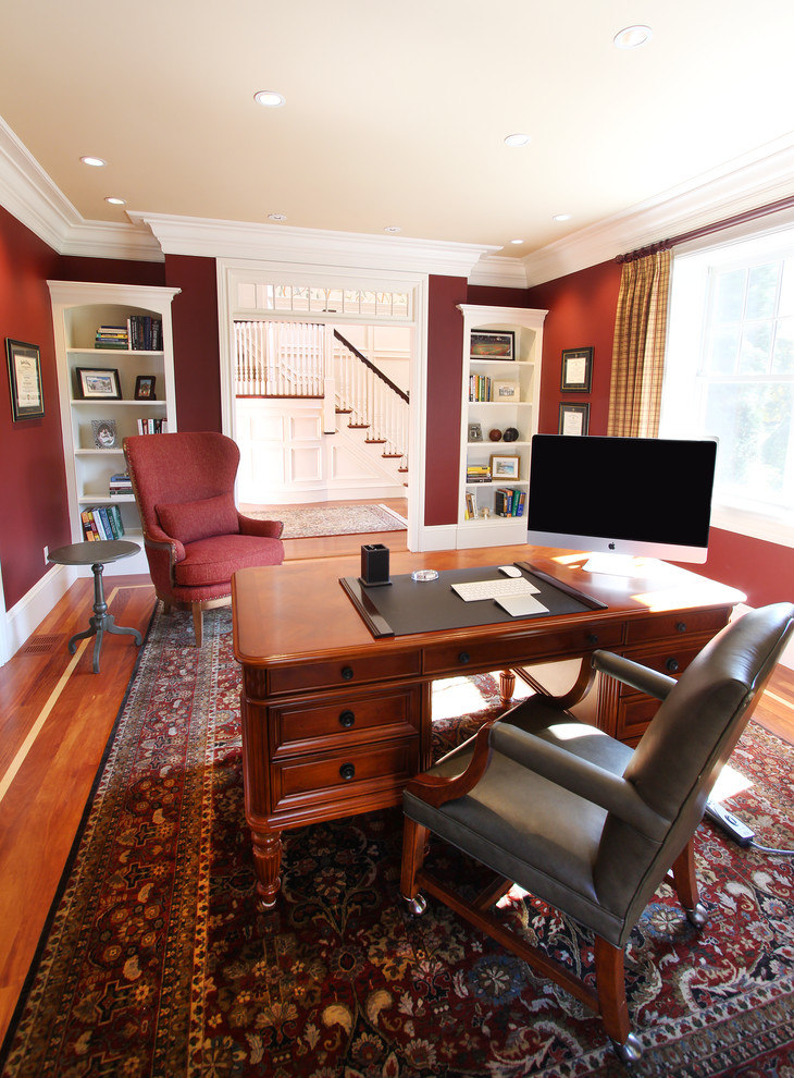 Стильный дизайн: кабинет среднего размера в классическом стиле с красными стенами, паркетным полом среднего тона, отдельно стоящим рабочим столом и коричневым полом без камина - последний тренд