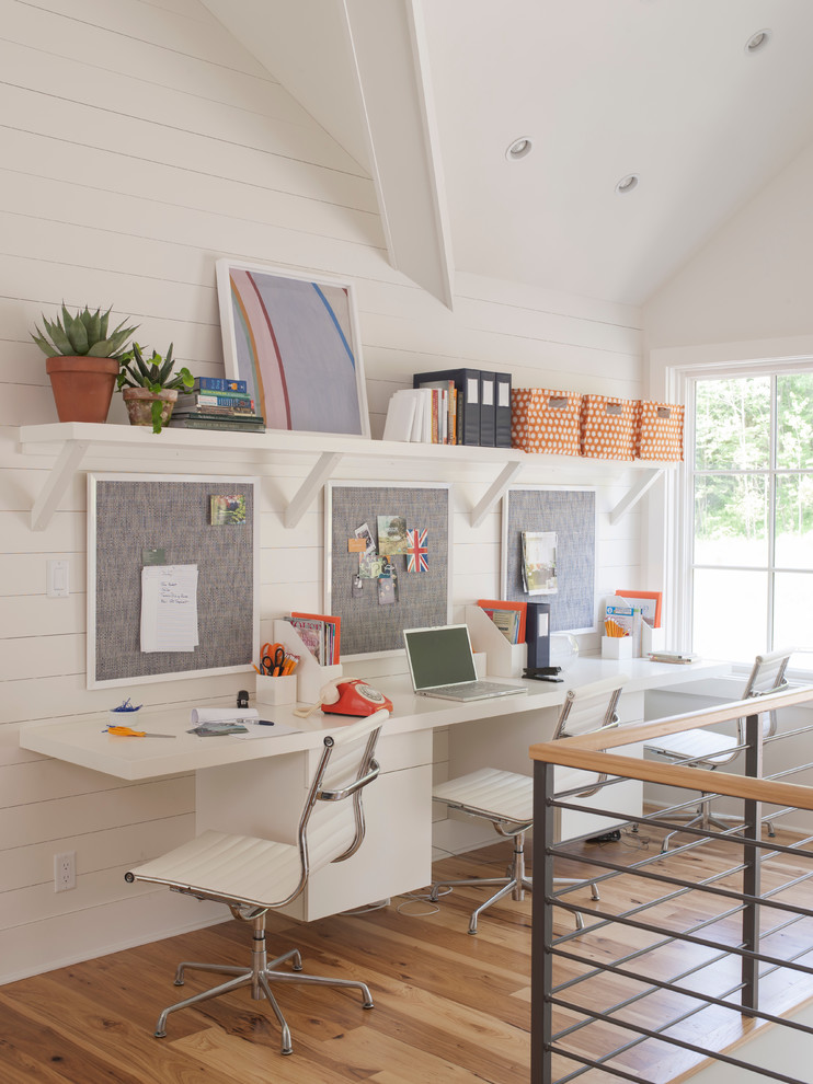 Inspiration for a mid-sized transitional built-in desk light wood floor study room remodel in Boston with white walls