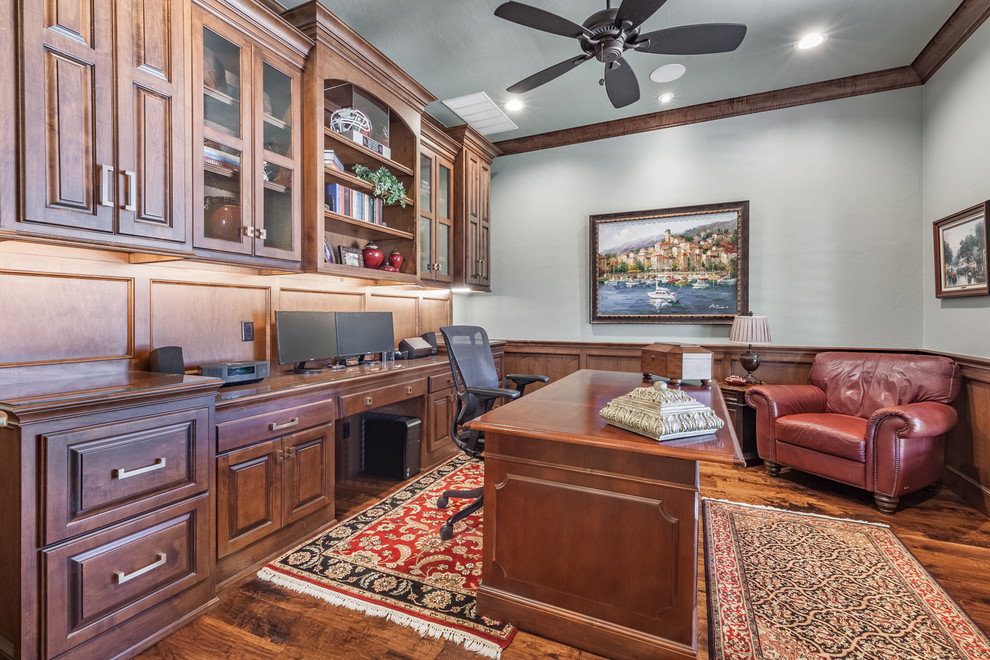 Medium sized classic study in Oklahoma City with grey walls, medium hardwood flooring, no fireplace, a freestanding desk and brown floors.