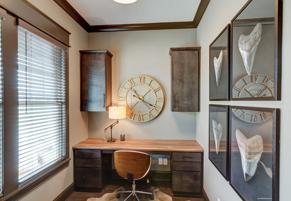 Example of a mid-sized trendy built-in desk medium tone wood floor study room design in Indianapolis with beige walls and no fireplace